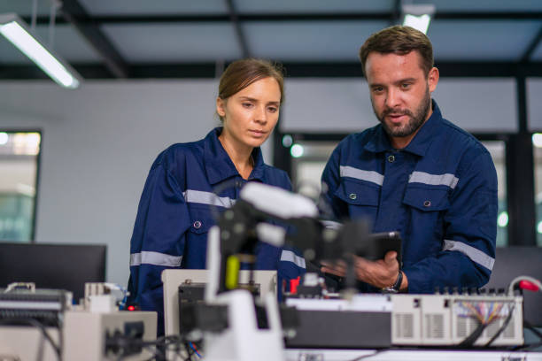 Engineers are working at robotics workshop. STEM and technology.