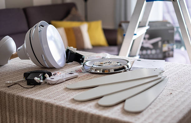 Accessories on the table ready to be assembled to install a paddle fan on the ceiling of the living room
