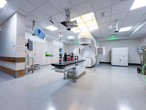 A modern medical treatment facility featuring a cutting-edge radiotherapy system for precision care. The room showcases a sterile and organized environment essential for delivering high-energy radiation beams as part of external beam radiation therapy. This space emphasizes technological sophistication and meticulous attention to enabling optimal patient treatment outcomes in modern oncology practices. 3D conformal radiotherapy, intensity-modulated radiotherapy (IMRT), and stereotactic radio surgery.
