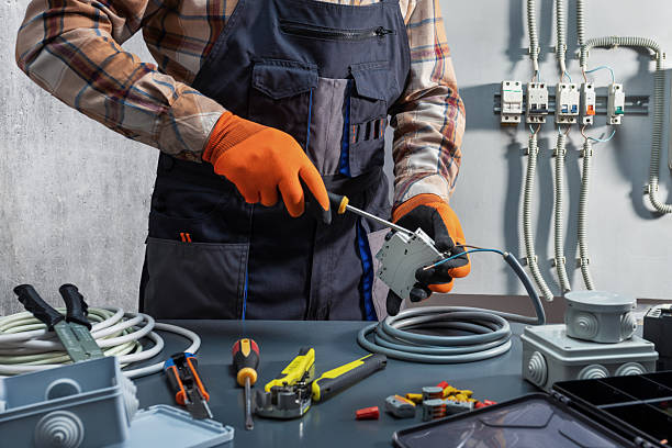 Electrician working with power switch.