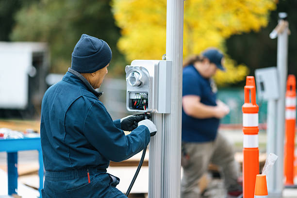 EV charge station technicians work diligently at putting in a new charging point access for environmentally friendly clean energy. Shot in Washington state.