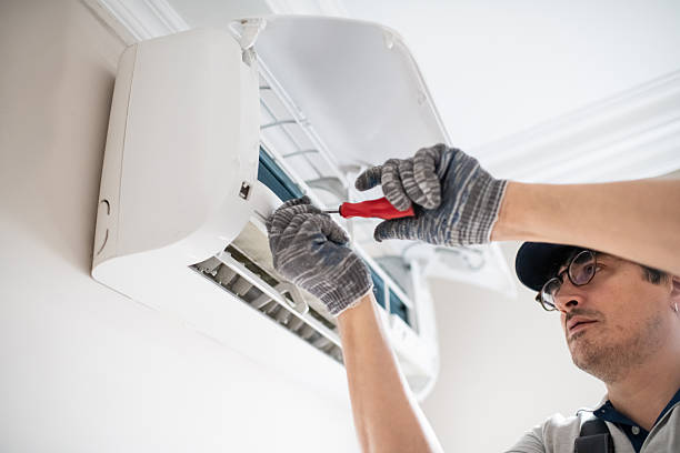 Man repairing air conditioner at home