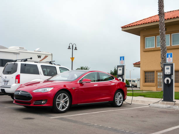 VENTURA, CA - JULY 4, 2013: Tesla electric car topping up its battery at a quick charging station while parked in Ventura Harbor Village
