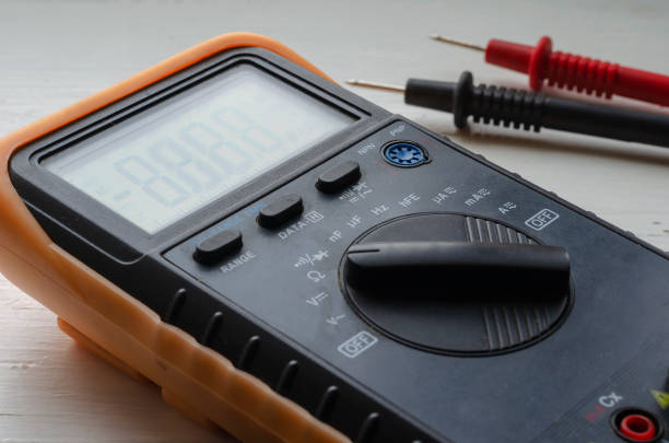 Close-up of a multimeter on a light background. Detailed shot of a measuring device. Qualified electrician services. Selective focus.