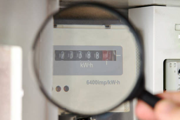 energy meter at white electricity box indoors. domestic life. check power consumption.