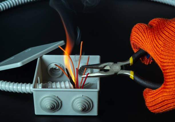 Short circuit in the mains. The hands of a master electrician close up or check during equipment repair.