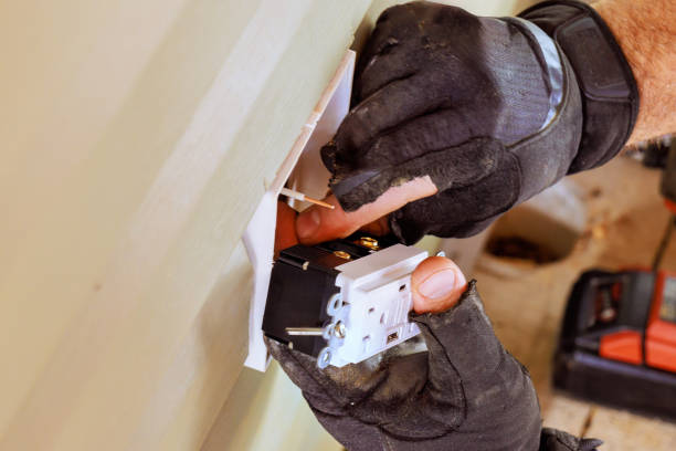 Installs electrical outlets sockets on exterior facade of house by an electrician